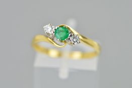 AN 18CT GOLD EMERALD AND DIAMOND RING, the central circular emerald flanked by brilliant cut