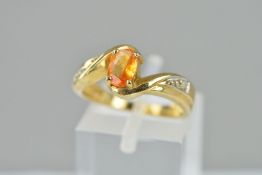 A MODERN BERYLLIUM TREATED YELLOW SAPPHIRE AND DIAMOND DRESS RING, ring size N 1/2, hallmarked 9ct