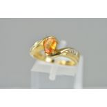 A MODERN BERYLLIUM TREATED YELLOW SAPPHIRE AND DIAMOND DRESS RING, ring size N 1/2, hallmarked 9ct