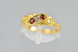 A LATE VICTORIAN 18CT GOLD RUBY AND DIAMOND RING the front panel of scrolling design set with two