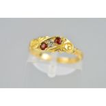 A LATE VICTORIAN 18CT GOLD RUBY AND DIAMOND RING the front panel of scrolling design set with two