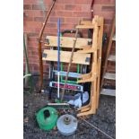 A FOLDING WORK BENCH, lawn aerator, three pine shelf brackets and garden tools