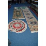 A WOOLLEN CARPET RUNNER, green ground, 333cm x 80cm and three other Chinese rugs (4)