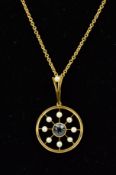 AN EARLY 20TH CENTURY AQUAMARINE AND SEED PEARL PENDANT, centring on a round mixed cut aquamarine