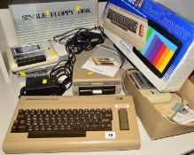 A BOXED COMMODORE 64 VINTAGE GAMING COMPUTER, with boxes of floppy disc drive, boxed 1530