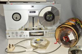 A VINTAGE AKAI GX-77 FOUR TRACK REEL TO REEL TAPE RECORDER, and a tin of tapes, The Akai powers