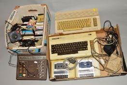 A COMMODORE 64, a Vic 20 with two trays of vintage gaming equipment, also includes a Binatone TV