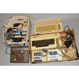 A COMMODORE 64, a Vic 20 with two trays of vintage gaming equipment, also includes a Binatone TV