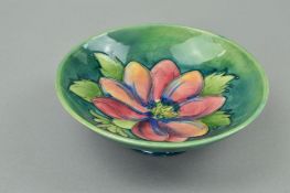 A MOORCROFT POTTERY FOOTED BOWL, 'Clematis' pattern on green ground, impressed marks to base and