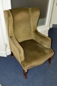 AN EDWARDIAN MAHOGANY FRAMED GREEN UPHOLSTERED WING BACK ARMCHAIR