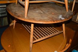 AN ERCOL 1960'S ELM AND BEECH OVAL TOPPED COFFEE TABLE with spindled undertier (in need of