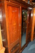 AN EDWARDIAN MAHOGANY AND INLAID TRIPLE DOOR COMPACTUM WARDROBE with central mirrored door and