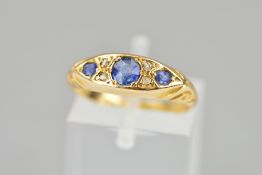 AN EDWARDIAN 18CT GOLD SAPPHIRE AND DIAMOND RING designed as three circular sapphires interspaced by