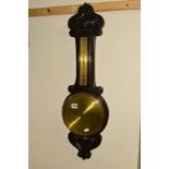 A 20TH CENTURY CARVED OAK ANEROID BAROMETER