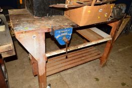 A WORKBENCH with two vices and a bench grinder