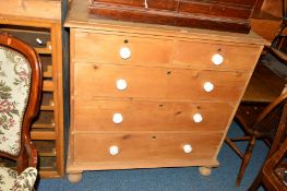 A VICTORIAN PINE CHEST of two short and three long drawers with ceramic knobs, approximate width