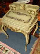 A VICTORIAN LADIES WRITING DESK, green ground with brass ormolu moulding, the fold over top below
