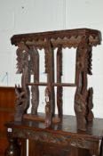 A 20TH CENTURY CARVED OAK OCCASIONAL TABLE with an undershelf and a modern bevelled edge wall mirror