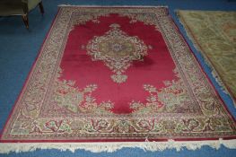 A WOOLLEN CARPET SQUARE, red ground, foliate design with central medallion, approximate size 203cm x