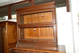 AN EARLY 20TH CENTURY OAK TWO SECTION BOOKCASE, with glazed fall front doors, Gunn sectional