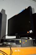 A SAMSUNG 23' LCD TV, a Sharp VHS / DVD player (two remotes)