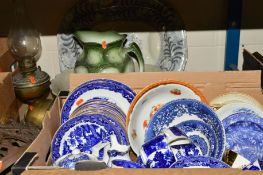 A BOX OF BLUE AND WHITE CHINA AND SUNDRY ITEMS to include a large platter, brass oil lamp, jug and