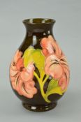 A MOORCROFT POTTERY VASE, 'Hibiscus' pattern on brown ground, impressed marks and painted