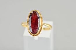 A 9CT GOLD GARNET RING, the oval shape garnet within a collet setting with a rope twist surround