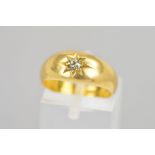 AN EDWARDIAN 18CT GOLD DIAMOND RING, the old cut diamond star set to the tapered plain band,