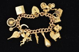 A 9CT GOLD CHARM BRACELET, the double curb link bracelet suspending twelve charms, to include a