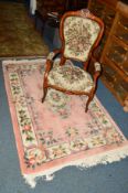 A CHINESE WOOLLEN RUG, pink ground, 188cm x 123cm and a modern elbow chair (2)