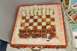 A CASED ONYX CHESS SET