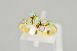 AN OPAL DRESS RING, designed as a central navette shape opal cabochon flanked by three circular opal