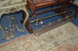 A VICTORIAN BRASS FENDER, and a brass curtain rail, brass companion set with two dogs, two pairs