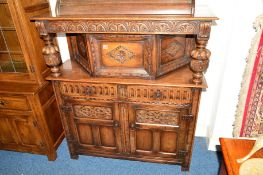 A REPRODUCTION CARVED OAK COURT CUPBOARD with two drawers, approximate width 115cm x depth 43cm x
