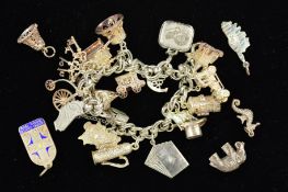 A MID TO LATE 20TH CENTURY SILVER CHARM BRACELET, together with eighteen assorted charms to