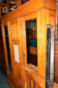 AN EDWARDIAN SATINWOOD THREE DOOR COMPACTUM WARDROBE with three internal slides above two drawers,