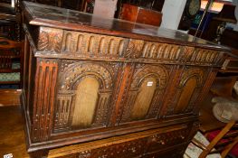 A REPRODUCTION CARVED OAK TRIPLE PANEL COFFER, approximate width 117cm x depth 48cm x height 61cm