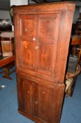 A GEORGIAN OAK PANELLED FLOORSTANDING FOUR DOOR CORNER CUPBOARD, approximate width 89cm x depth 45cm