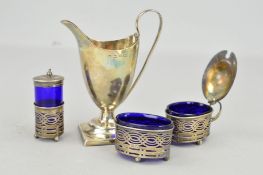 AN EARLY 20TH CENTURY CRUET SET AND A LATE VICTORIAN CREAM JUG, the cruet set with blue glass liners