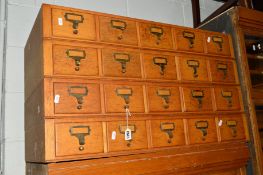 A LIGHT OAK FOUR SECTION HABERDASHERY INDEX CABINET comprising of twenty drawers, approximate