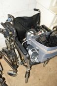 AN INVACARE IMPERIAL FOLDING WHEELCHAIR with separate added TGA electric leisure motor and a