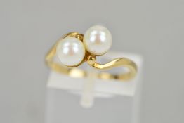 A CULTURED PEARL RING, of crossover design set with two cultured pearls and bead detail, stamped