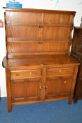 AN ERCOL ASH DRESSER, with two tier plate rack above two drawers and cupboard base, approximate size
