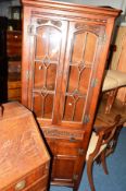 AN OLD CHARM OAK LEAD GLAZED CORNER CABINET and a similar CD cabinet (2)