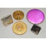 FIVE VINTAGE COMPACTS to include a large circular, purple guilloche enamel compact, a floral Kigu