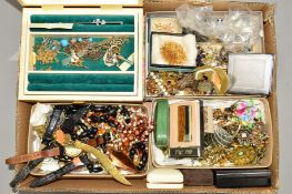 A BOX OF COSTUME JEWELLERY to include a late Victorian carved jet brooch, a green paste and