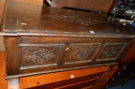 A CARVED OAK PANELLED COFFER, approximate width 106cm x depth 45cm x height 45cm