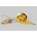 THREE EARLY 20TH CENTURY GOLD BROOCHES, the first of oval outline set with a citrine within a rope