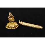 A 9CT GOLD FOB AND A PLATED RETRACTABLE PENCIL, the fob with navette shape base, knot and bead